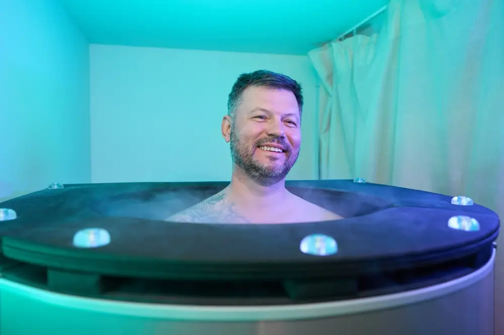 Wellness center patient enjoying whole body cryotherapy session
