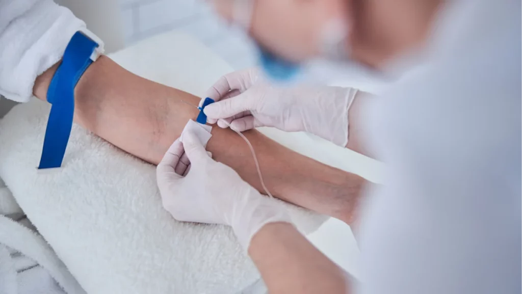 Focused image of female sitting in the cosmetic chair while receiving IV infusion in medicine center